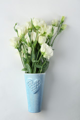 Vase with beautiful flowers on white background
