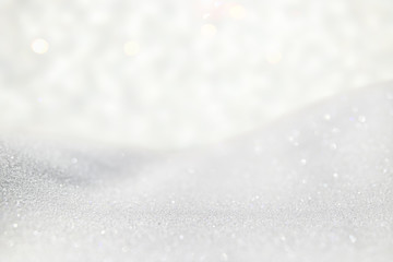 glitter vintage lights background. silver and white. de-focused