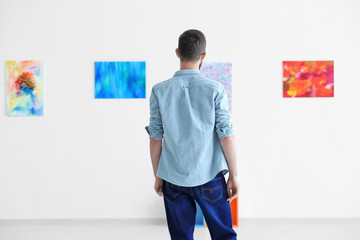 Young man in art gallery