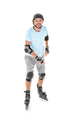 Handsome man on roller skates against white background