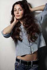 Young beautiful slim girl with long curly hair and clean make-up