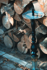 Hookah on a wooden background in the autumn afternoon.
