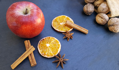 Apple ,dried orange slices, cinnamon sticks and walnuts