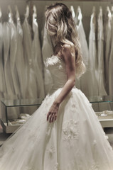 Bride is trying on wedding dress.