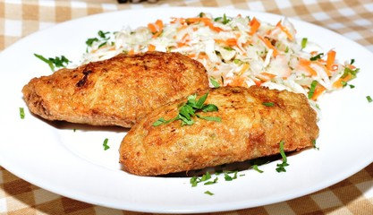 Two potato meatballs with a vegetable garnish