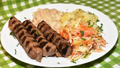 Triple kebabs of delicious calf minced with cabbage, beans and potatoes