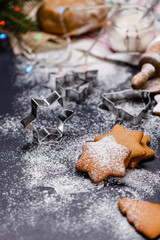 Christmas ginger cookies on a black background, vertically