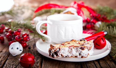 Dresdnen Stollen is a Traditional German Cake with raisins on a light knitted background.Gift for Christmas.Vintage style.Fruit cake for the Holiday. German, European festive dessert.