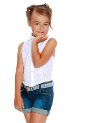 Fototapeta premium A little girl in shorts and a white shirt.