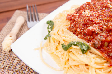 Spaghetti bolognese on a wooden background