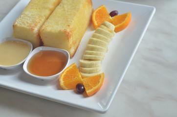 Toast with honey and Sweetened Condensed Milk,and banana dessert ,on White marble table.in cafe.