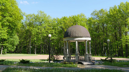 Beautiful gazebo in autumn park. Luxury ornate gazebo in a spring park