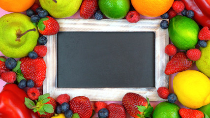 Fototapeta na wymiar Message board blackboard surrounded by healthy food, fruit and vegetables with copy space for your text here.