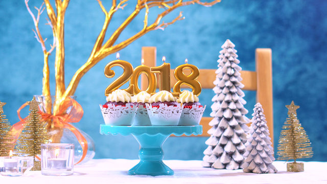 Happy New Year 2018 cupcakes on a modern stylish, festive, blue gold and white Winter theme table setting.