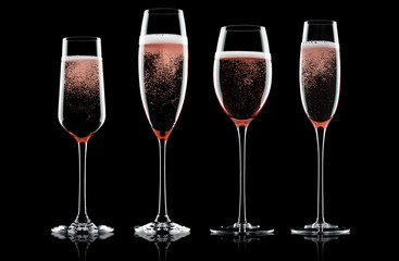 Champagne rose glasses with bubbles on black