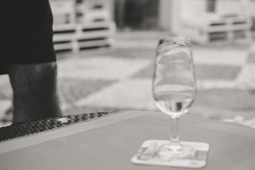 Close up on hand holding mobile smartphone and winetasting restaurant background. Modern internet connection networking, texting online luxury lifestyle