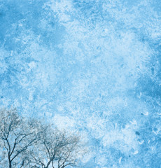 Fototapeta premium Background page design for a photo book, scrapbook or wallpaper in sky blue; abstract stone textures with winter trees