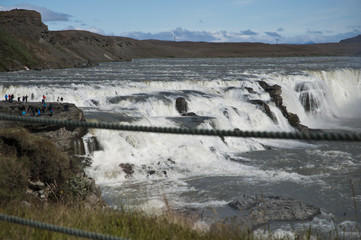 Typical Icelandic landscape of Gullfos Falls, a wild nature of rocks and shrubs.