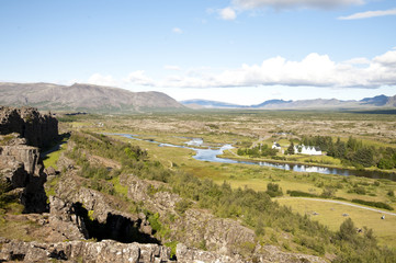 Fototapeta na wymiar National Park Thingvellir - Almannagjà canyon, Typical Icelandic landscape, a wild nature of rocks and shrubs, rivers and lakes.