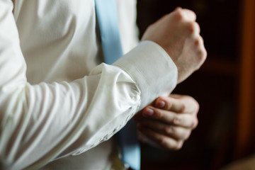 Fototapeta premium The man in the white shirt runs cuffs