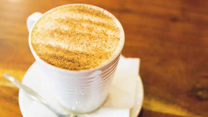 cappuccino cup on the brown wooden table