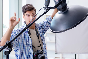 Young photographer working in photo studio