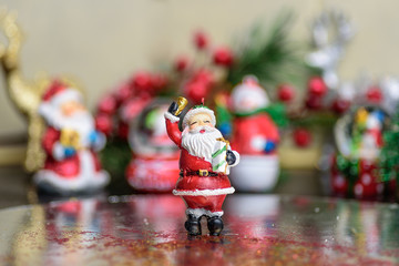 Small Christmas ornaments arranged into a holiday festive scene
