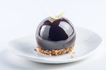 Beautiful truffle cake covered with glossy dark chocolate glaze. Concept design desserts