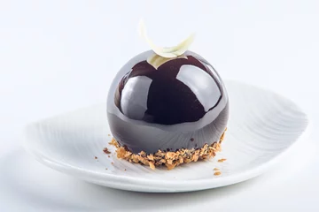 Fototapeten Beautiful truffle cake covered with glossy dark chocolate glaze. Concept design desserts © Artem