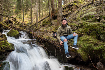 Naklejka na ściany i meble Hipster Adventurer hikes along Lake Obernberg in the mountains of Austria