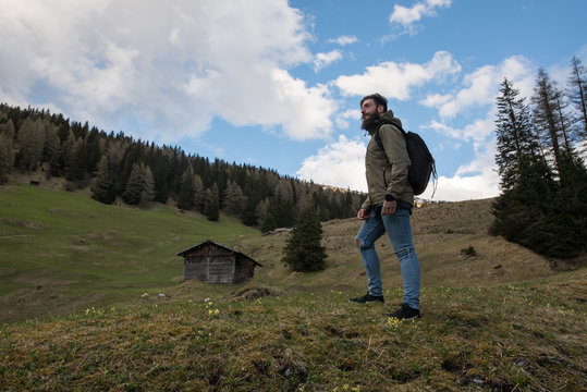 Hipster Adventurer hikes along Lake Obernberg in the mountains of Austria