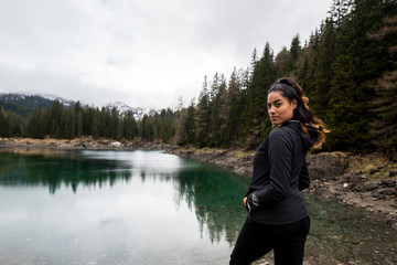 Girl hikes along Lake Obernberg in the mountains of Austria