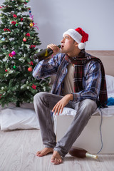 Fototapeta premium Man suffering hangover after christmas party