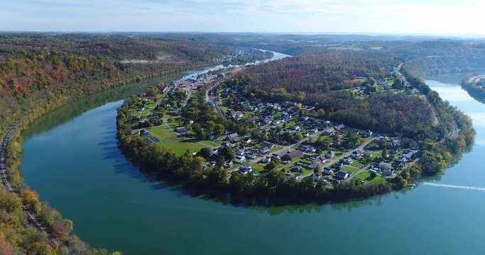 A high angle slow push forward establishing shot of the small mill town of Newell, Pennsylvania nestled on a bend of the Monongahela River just south of Pittsburgh, PA.	