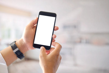 Businessman's hands holding and using mobile smartphone in office. Blank screen for graphics display montage.