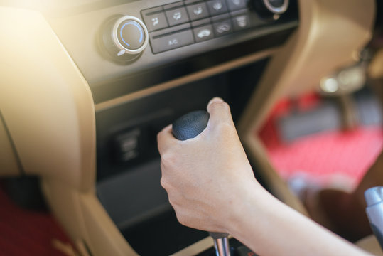Hand woman on automatic gear shift, Cropped image