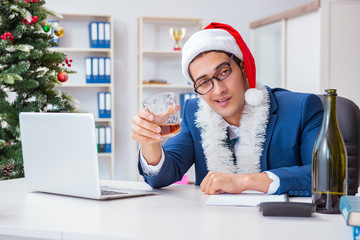 Businessman celebrating christmas holiday in the office