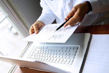 doctor working on a computer at his cabinet