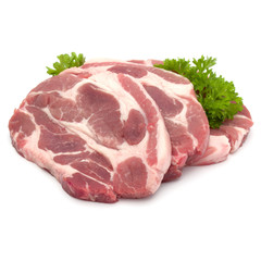 Raw pork neck chop meat with parsley herb leaves garnish isolated on white background cutout