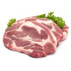 Raw pork neck chop meat with parsley herb leaves garnish isolated on white background cutout
