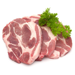 Raw pork neck chop meat with parsley herb leaves garnish isolated on white background cutout