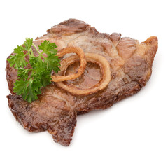 Cooked fried pork meat with parsley herb leaves and onion slices garnish isolated on white background cutout