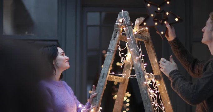 Couple decorating an alternative christmas tree