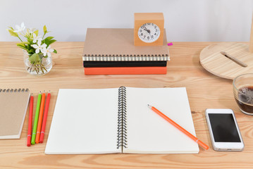Blank notebook on wooden table at home office