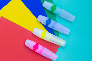 Bright green, yellow, blue,red markers or felt pen on sheets of colored paper.