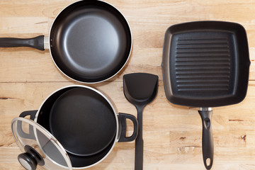 Empty set of Pan And Spatula Top View on wood background.