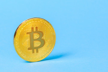 Coin bitcoin on a blue background with empty space for text