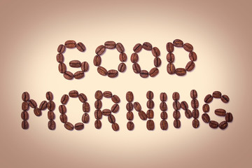Word good morning of coffee beans brown background