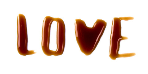 Words of love from a spray of spilled coffee isolated on white background