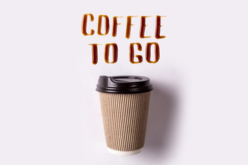 Letters of spilled coffee. Paper cup and coffee take-out. Coffee to go